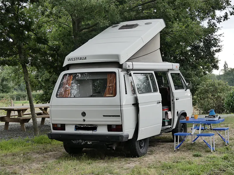 petite-img-tao-7 Image de "Tao" en bivouac en pleine nature en Rhône Alpes. La table et les chaises sont sorties. Ce van est en location chez Ryôko - spécialiste de la location de vans pour slow travel dans la Loire.